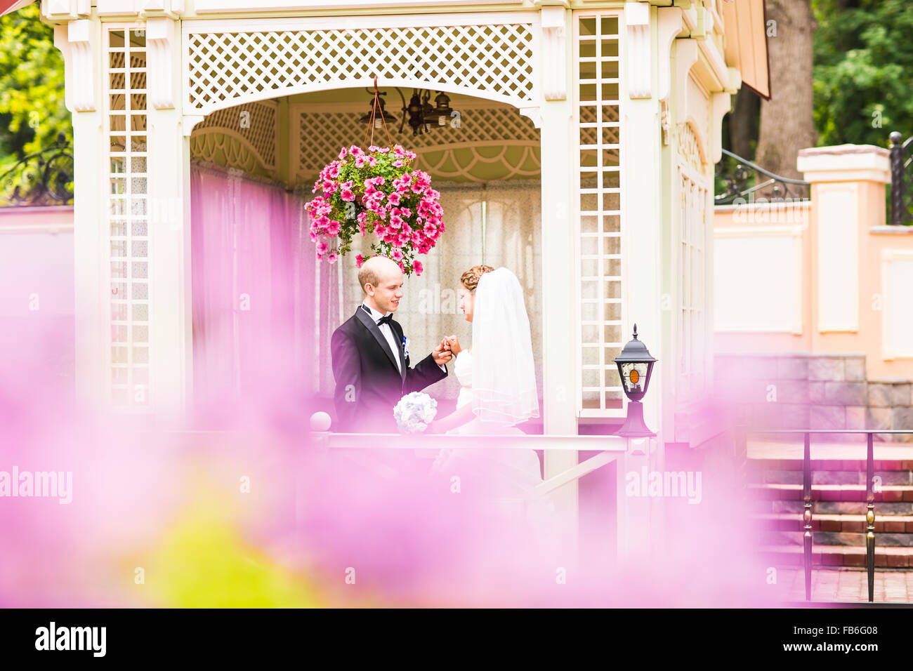 bride and groom in the gazebo Stock Photo - Alamy