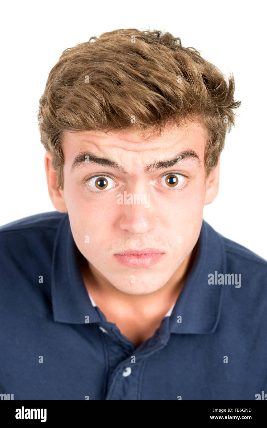 Surprised teenage boy making faces isolated in white Stock Photo