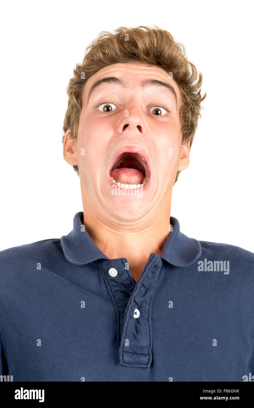 Surprised teenage boy making faces isolated in white Stock Photo