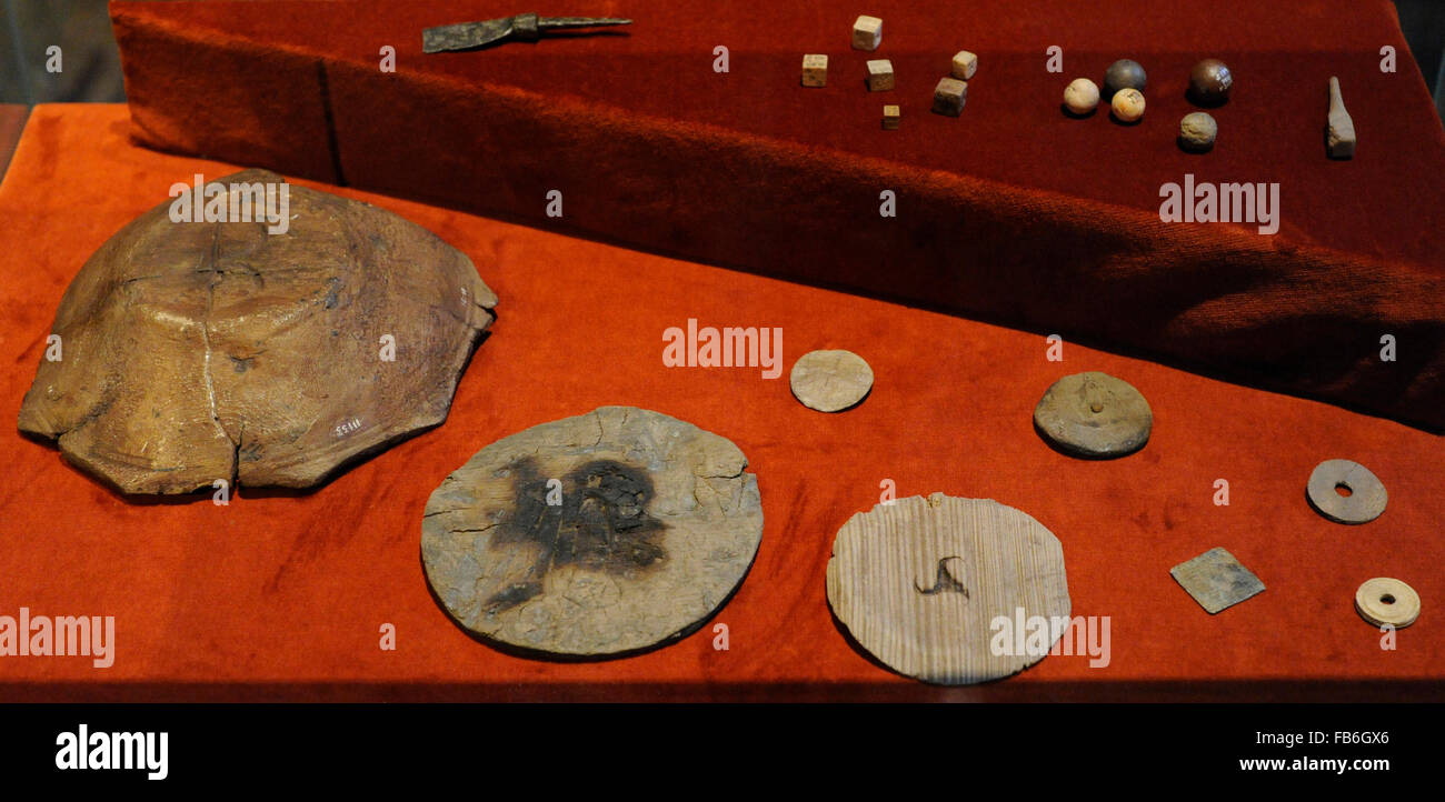 Medieval history. Scandinavia. Different objects with the mark of owner. In the background, dice and backgammon pieces. Medieval Museum. Stockholm. Sweden. Stock Photo