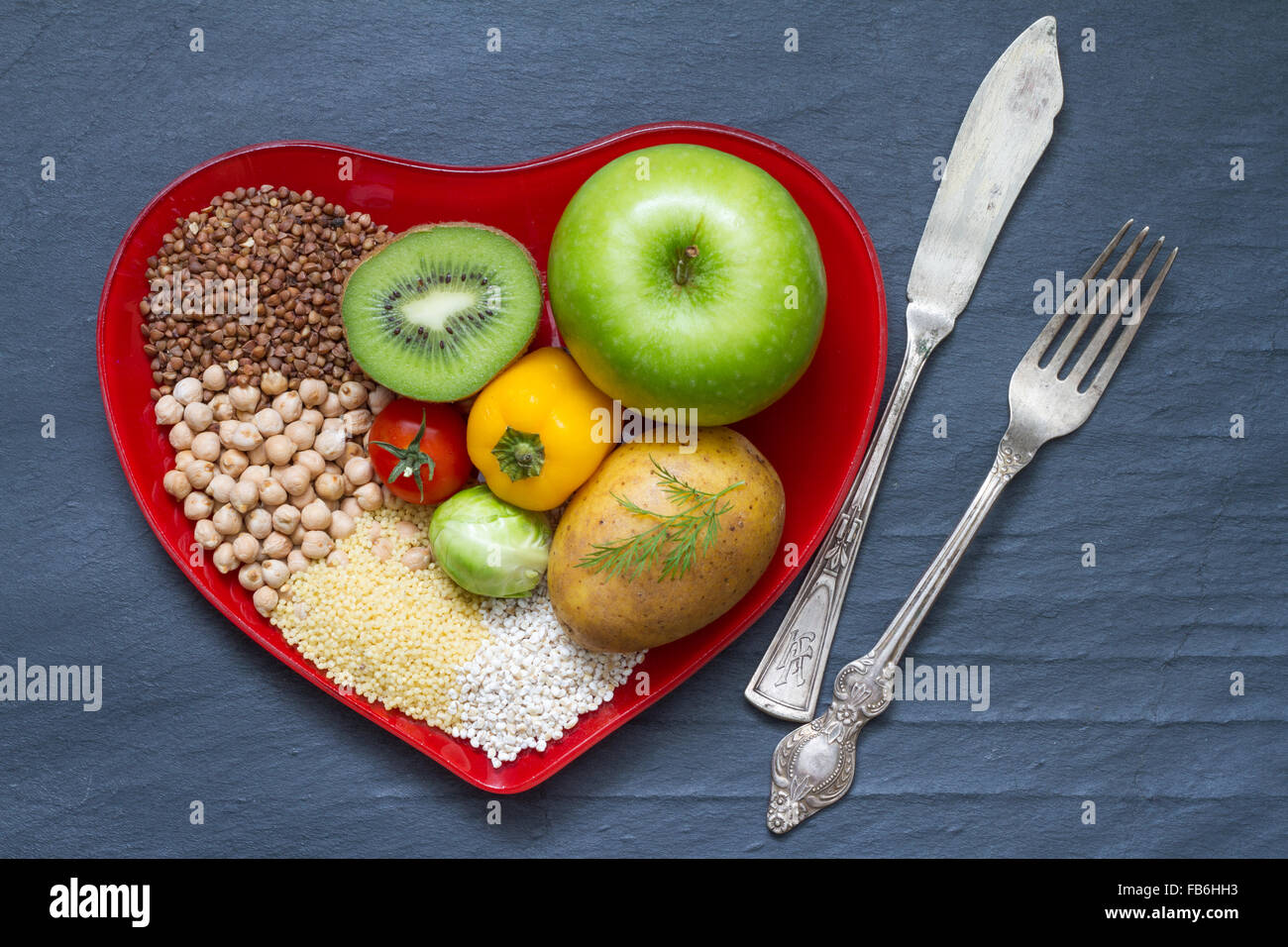 Health food on a red heart plate diets abstract still life concept Stock Photo