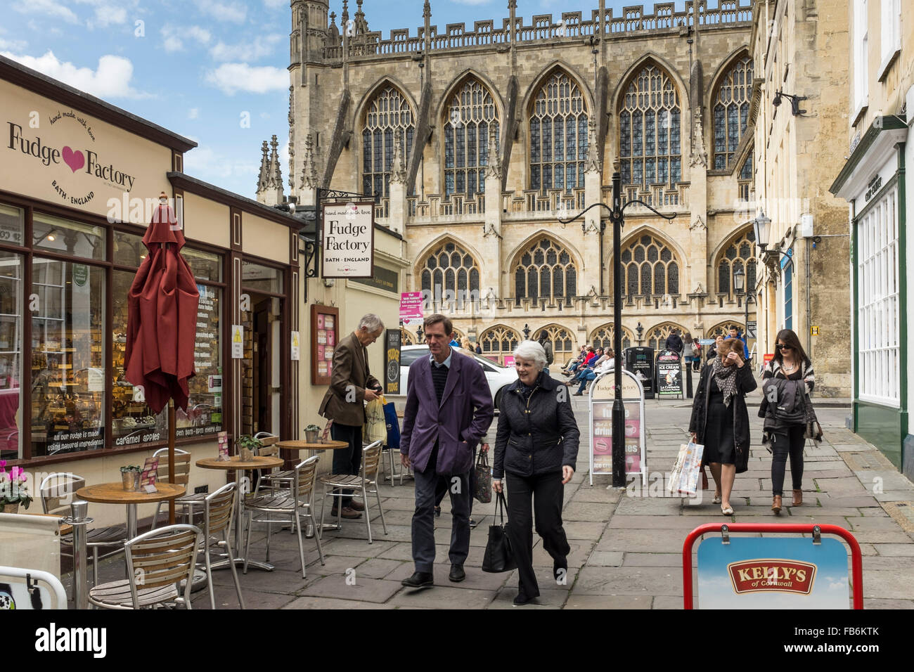 Pedestrians in Abbey Street with Bath Abbey in the background, Somerset, UK Stock Photo