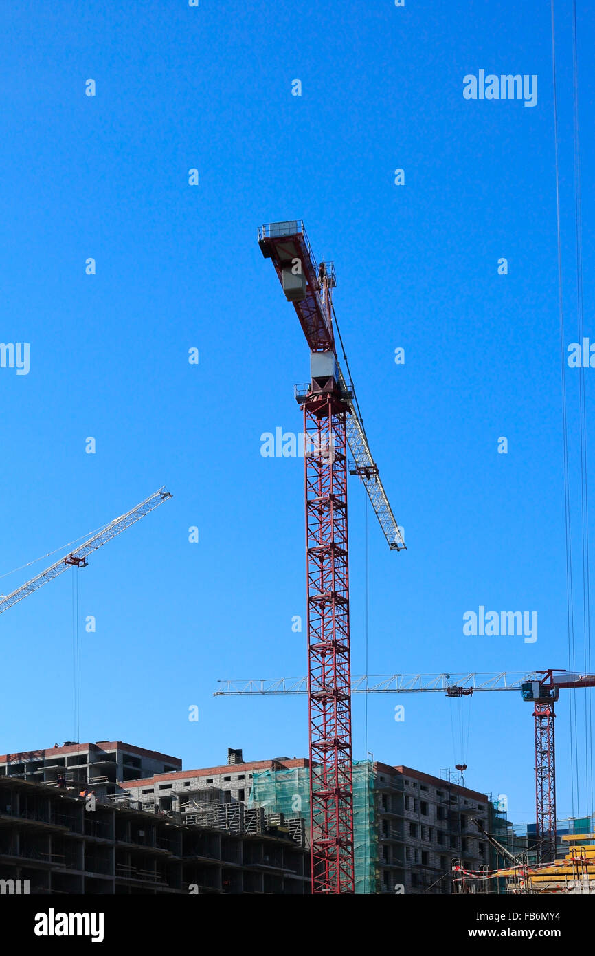 Cranes at the construction site of new buildings. Stock Photo