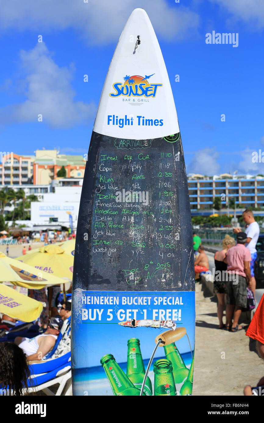 The Surf Board at the Sunset Beach Bar displaying all the major daily flight arrivals at the Princess Juliana Airport Stock Photo