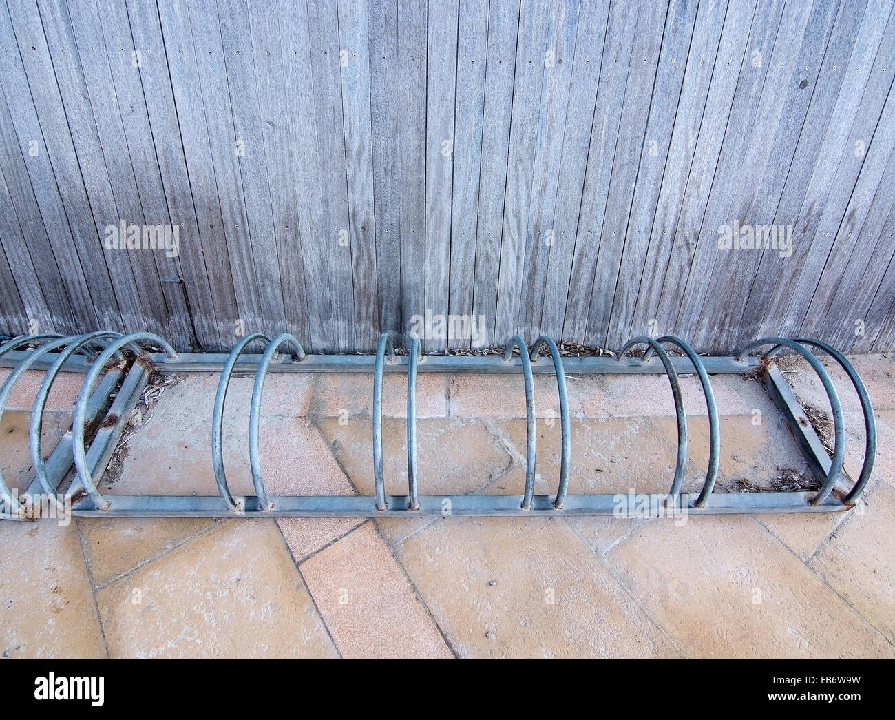 Zinc bike rack with stone and wood material Stock Photo - Alamy