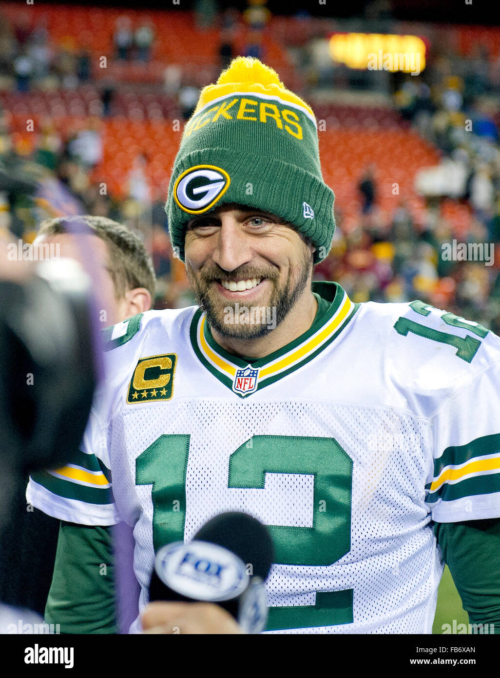 Green Bay Packers quarterback Aaron Rodgers (12) is all smiles as he prepares to be interviewed following his team's 35 - 18 victory over Washington Redskins in an NFC Wild Card game at FedEx Field in Landover, Maryland on Sunday, January 10, 2016. Credit: Ron Sachs/CNP - NO WIRE SERVICE - EDITORIAL USE ONLY unless licensed by the NFL Stock Photo