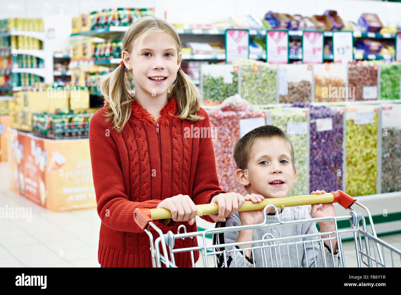 Children with cart shopping in supermarket Stock Photo Alamy