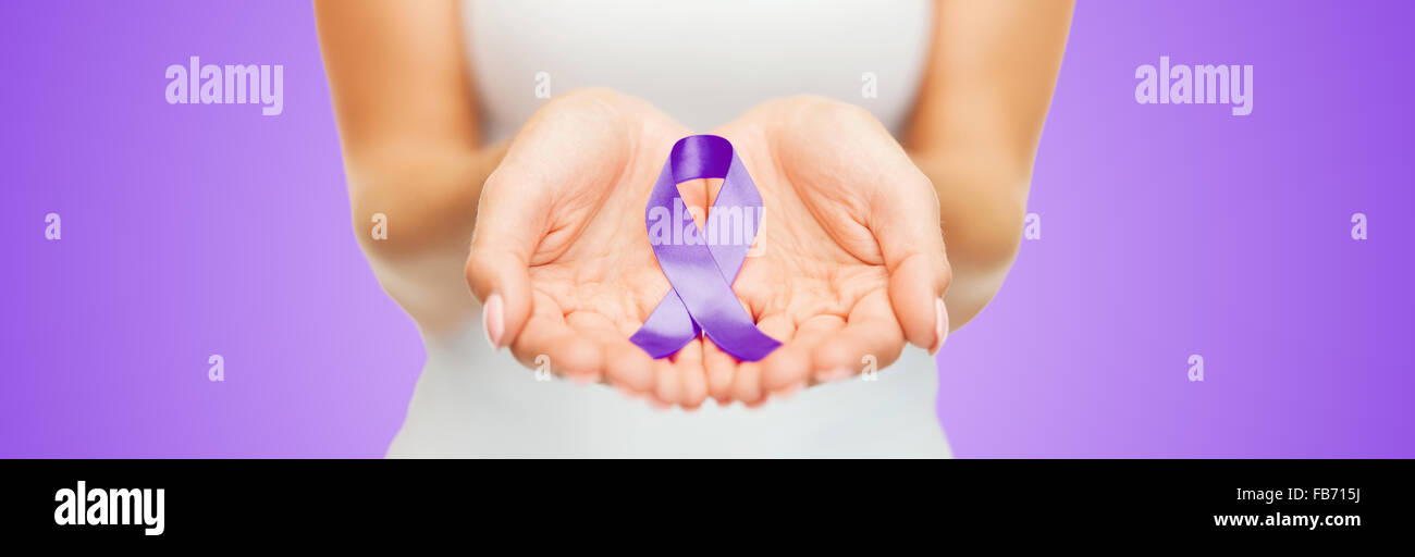 close up of hands holding purple awareness ribbon Stock Photo - Alamy