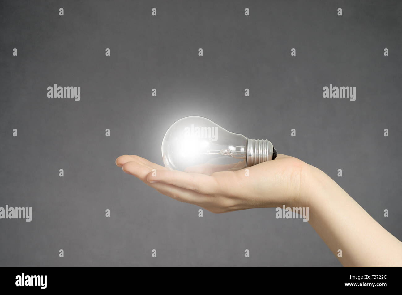 Creativity concept. Hand holding a glowing light bulb Stock Photo - Alamy