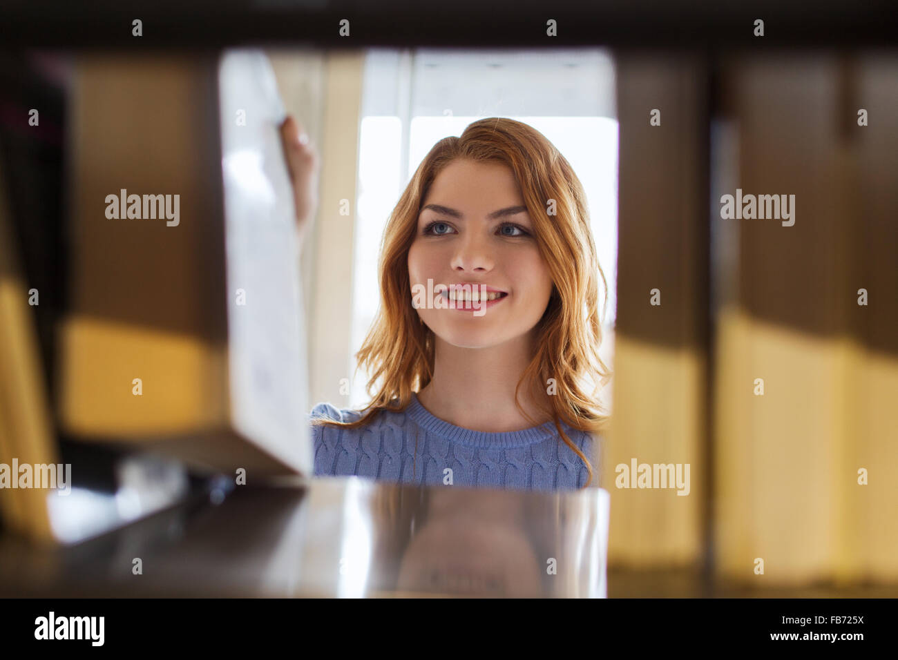 happy student girl or woman with book in library Stock Photo - Alamy