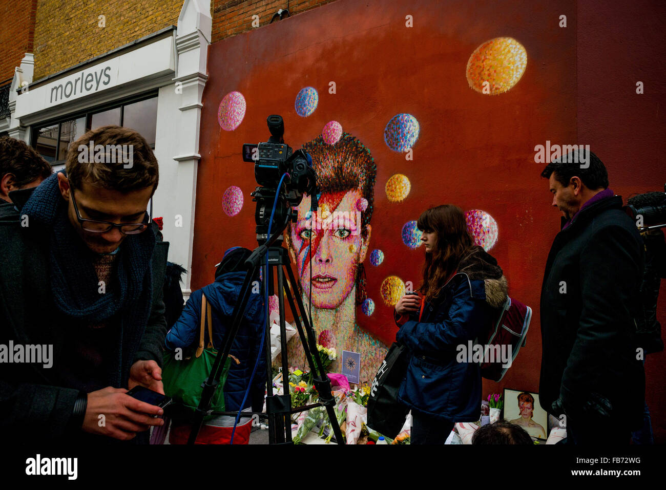 Jan. 11, 2016 - London, UK - Londoners paying tribute to David Bowie at a mural to the star in Brixton, where he grew up. Bowie dies today of cancer aged 69. (Credit Image: © Velar Grant via ZUMA Wire) Stock Photo
