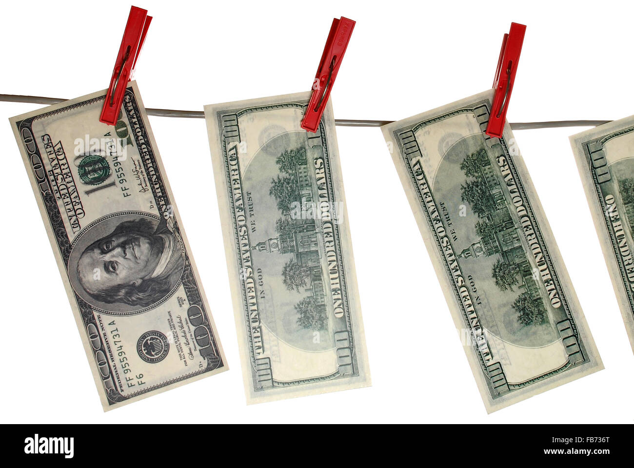 the crumpled 100 dollar bills hanging on a clothesline on a white background. Stock Photo