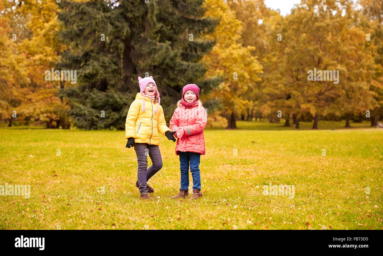 two happy little girls in autumn park Stock Photo - Alamy