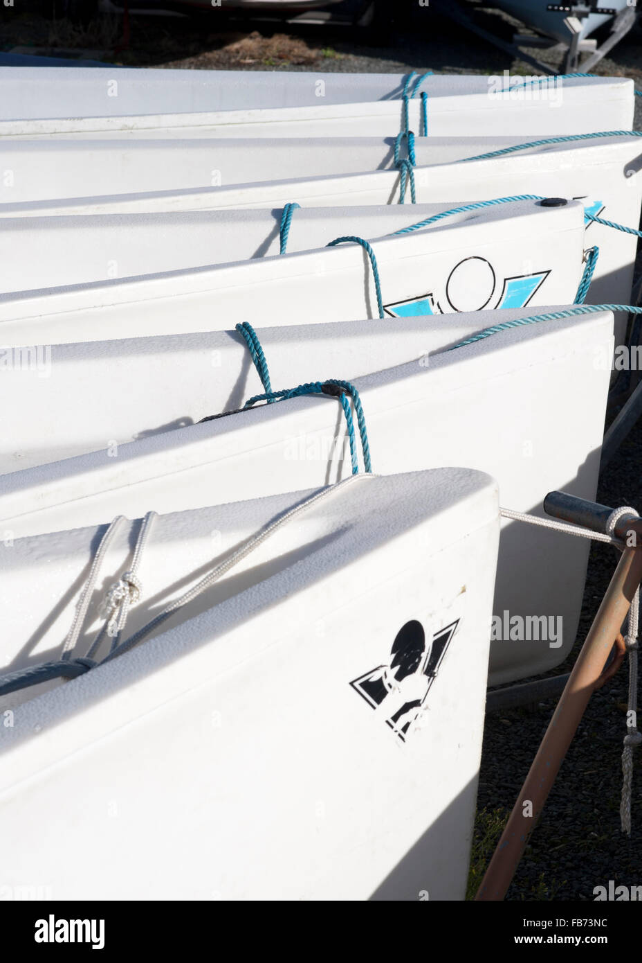 White sailing boats dinghys in a line on the dock Stock Photo - Alamy