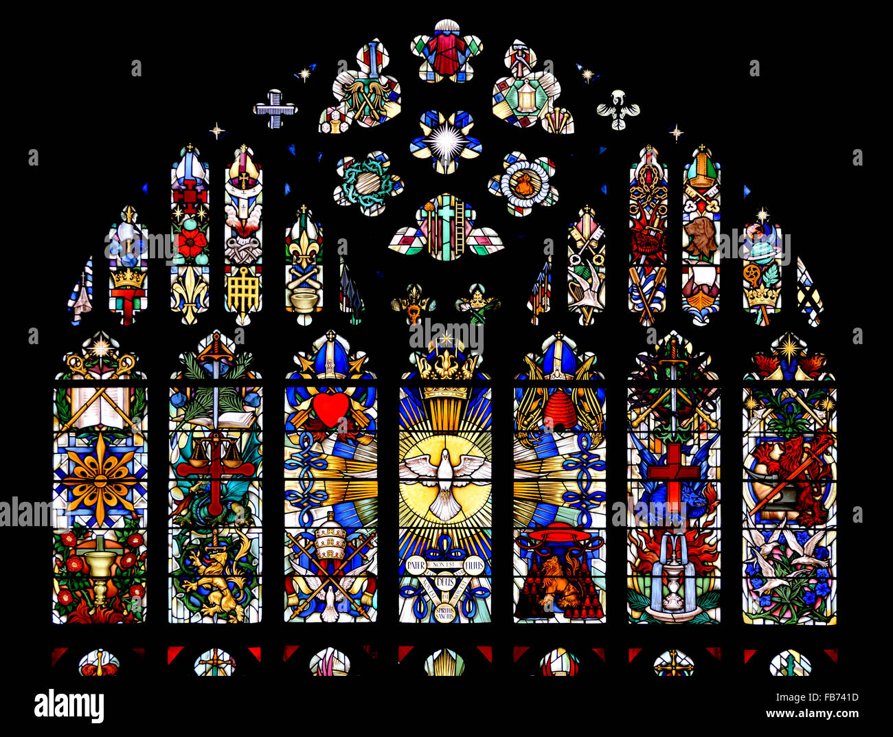 London, England, UK. Parish Church of St Luke, Chelsea. East window (1959: Hugh Easton) showing symbols of the saints Stock Photo