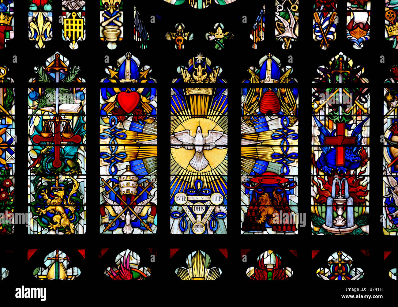 London, England, UK. Parish Church of St Luke, Chelsea. East window (1959: Hugh Easton) showing symbols of the saints Stock Photo