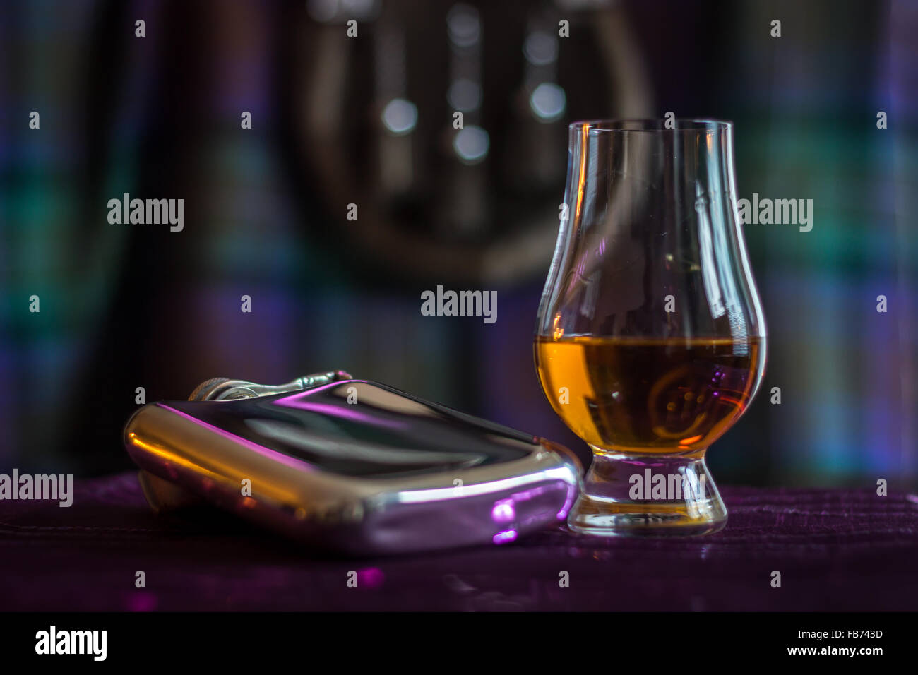 Whisky in a glass next to a hip flask Stock Photo Alamy