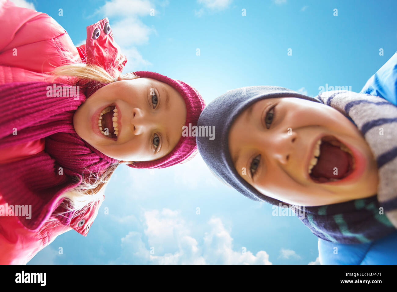 happy little boy and girl faces over blue sky Stock Photo - Alamy