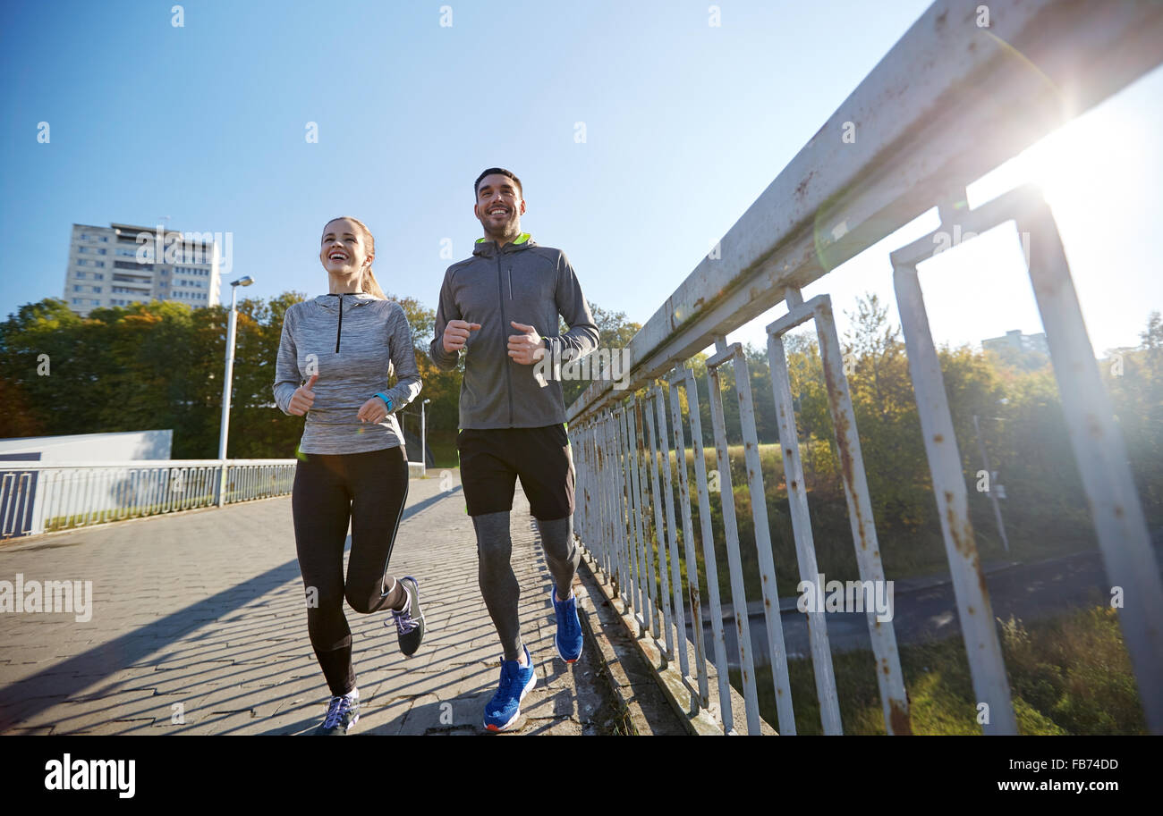 happy couple running outdoors Stock Photo - Alamy