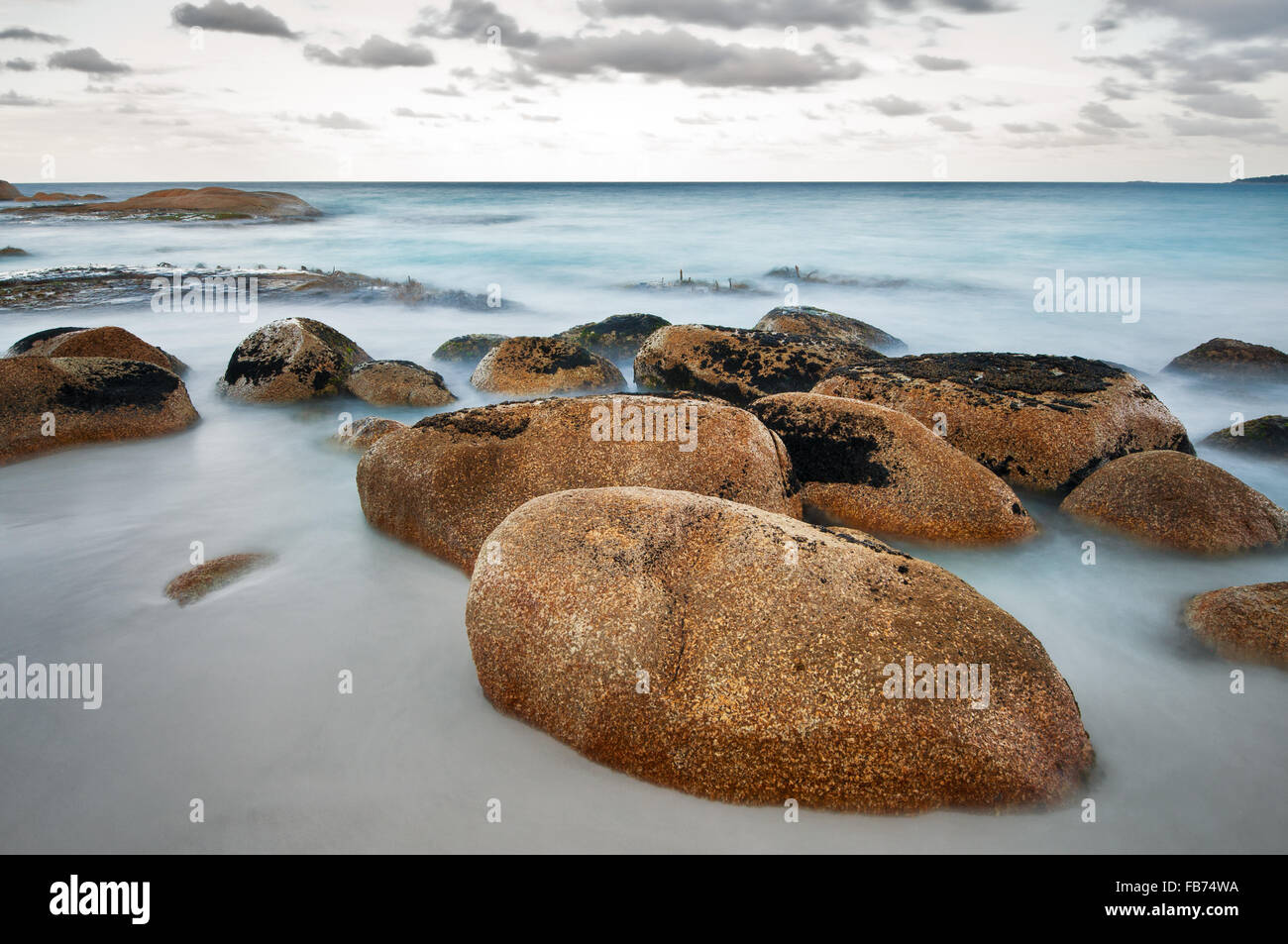Smooth boulder at the beach of Cosy Corner in the Bay of Fires. Stock Photo