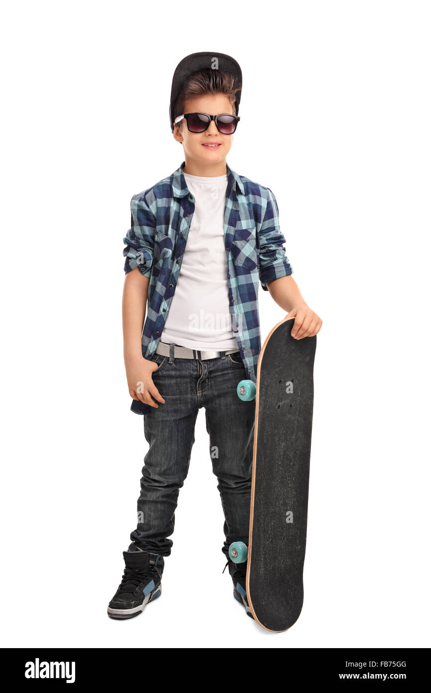 Full length portrait of a cool little skater boy with a cap and black sunglasses isolated on white background Stock Photo