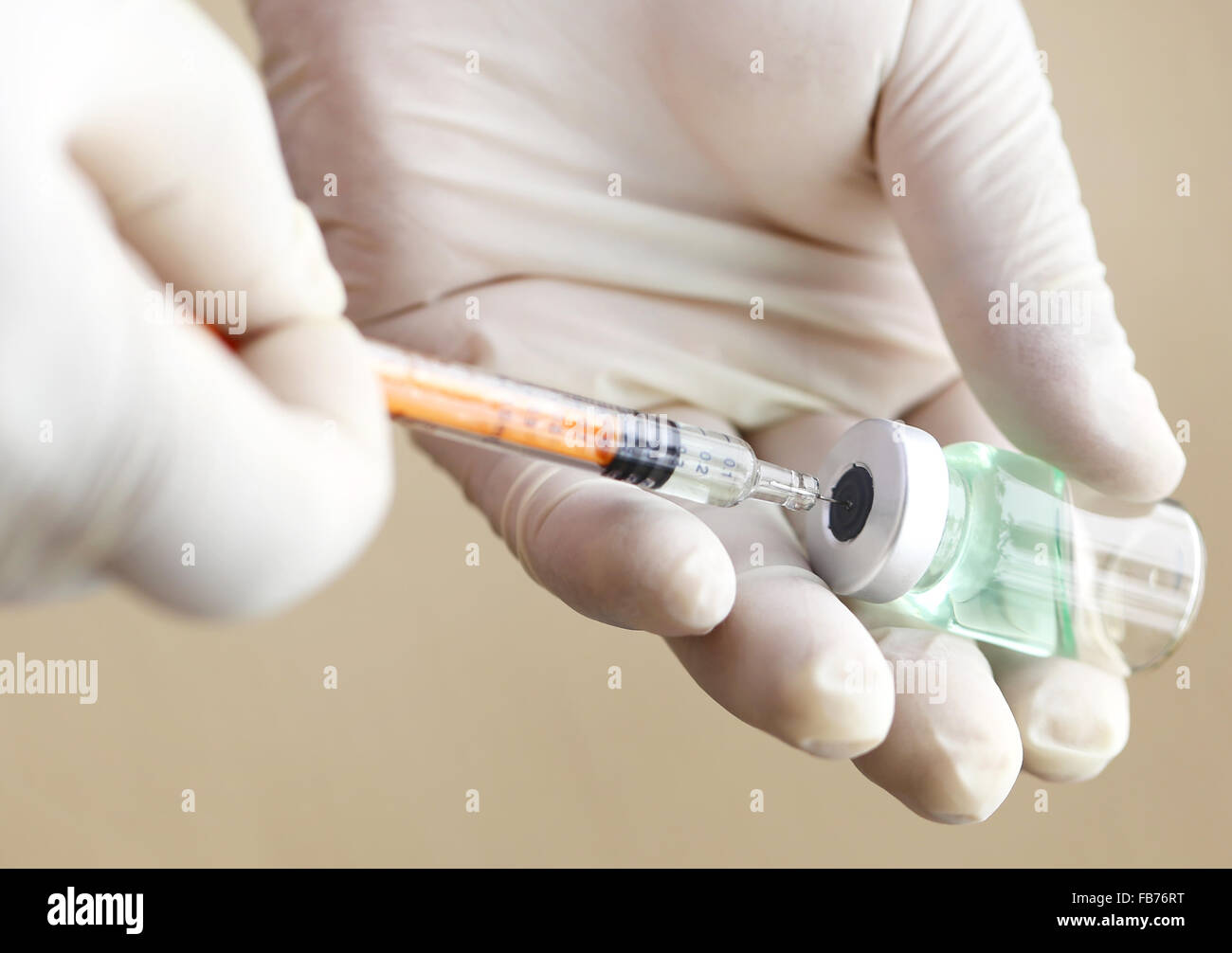 Syringe with vial in hand of a physician Stock Photo