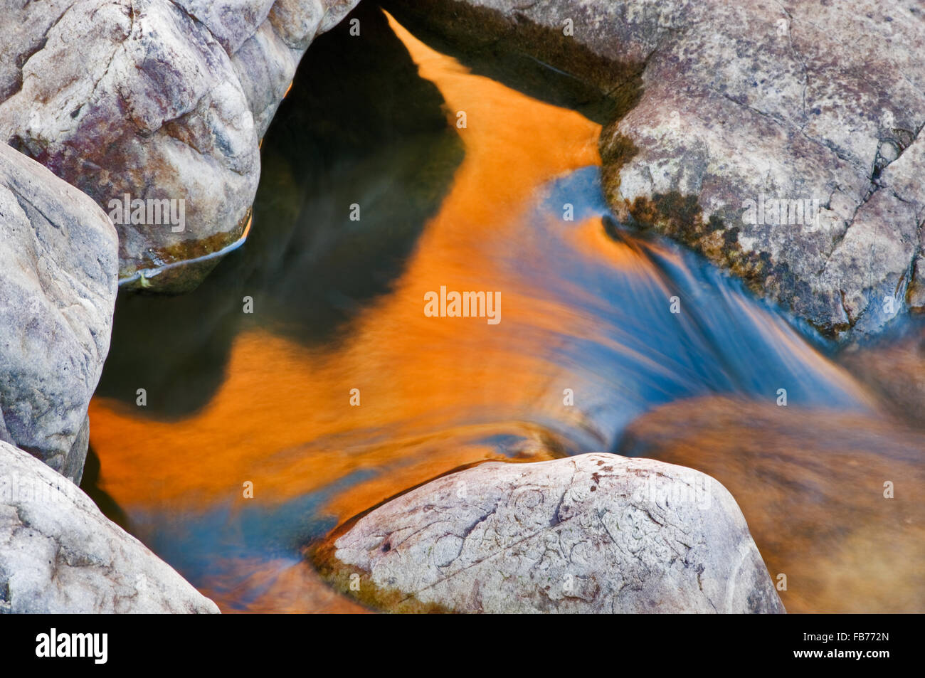 Red Glowing Rocks Red glowing rock wall reflecting in Ormiston Creek Stock Photo - Alamy