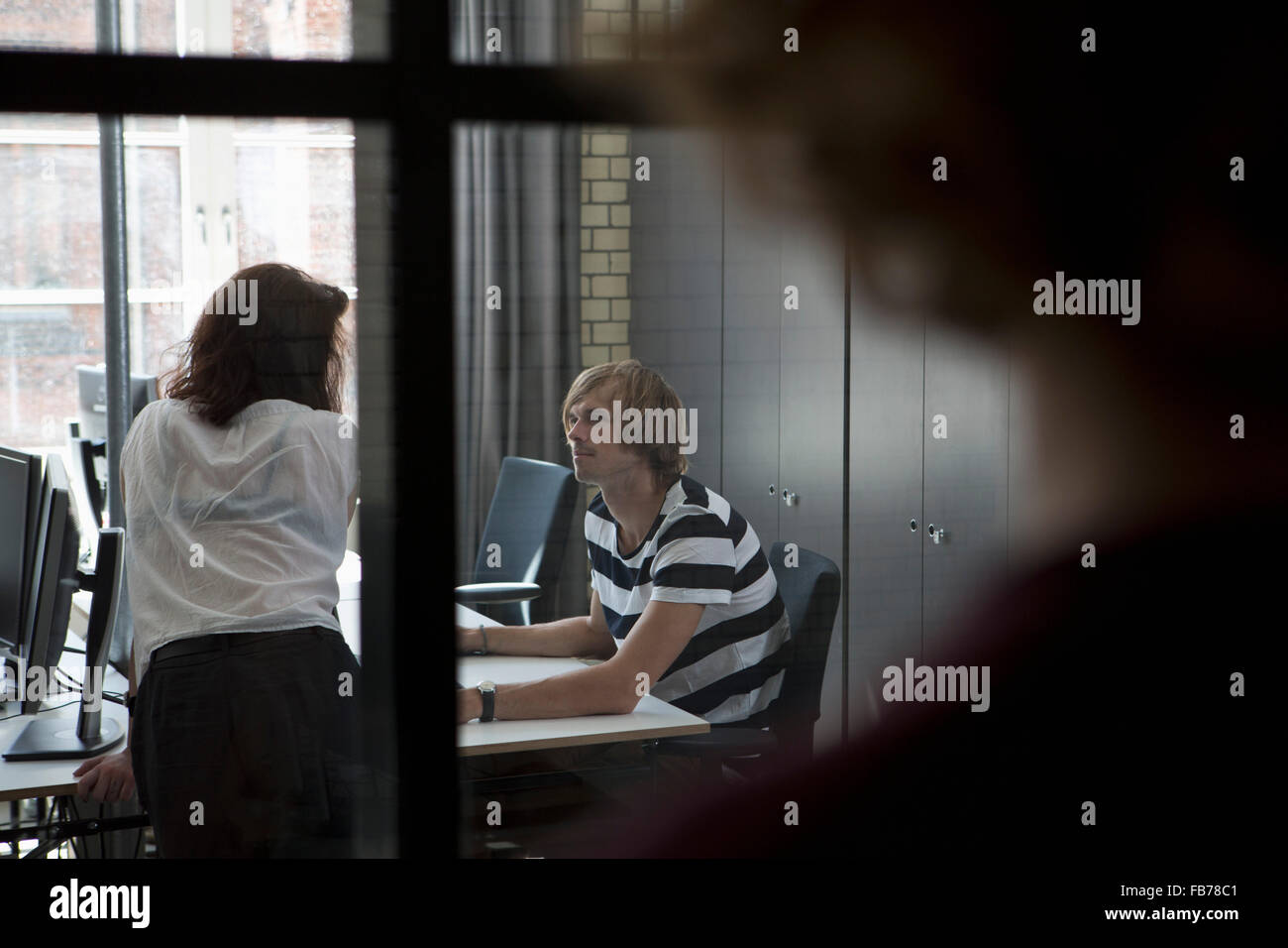 Man and woman talking with each other in office Stock Photo - Alamy