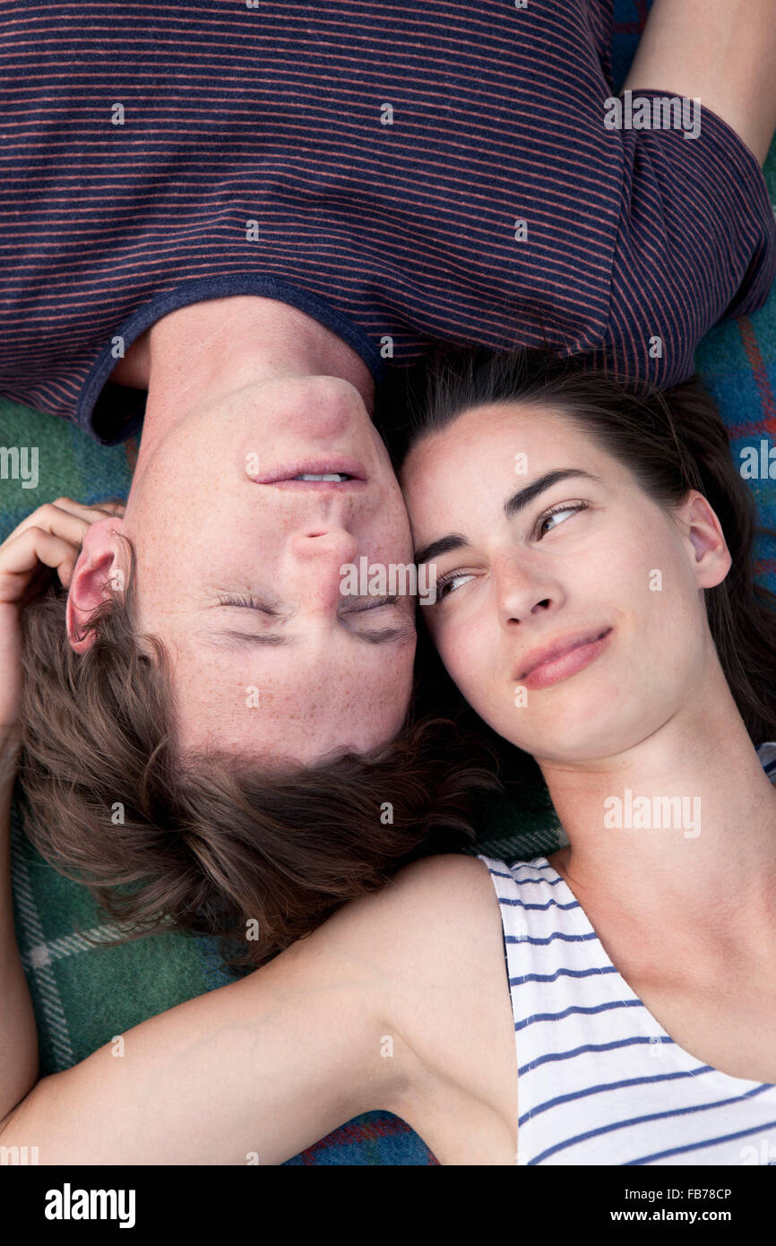 Young couple lying on picnic blanket Stock Photo
