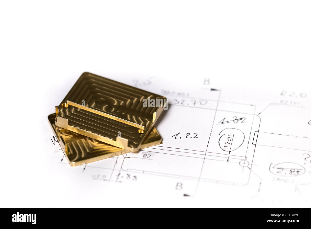 Ready CNC golden and silver metal detail on technical drawing sketch with measures Stock Photo