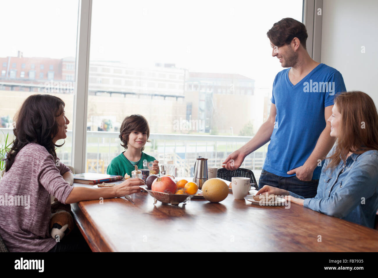 Family having breakfast at dining table Stock Photo Alamy