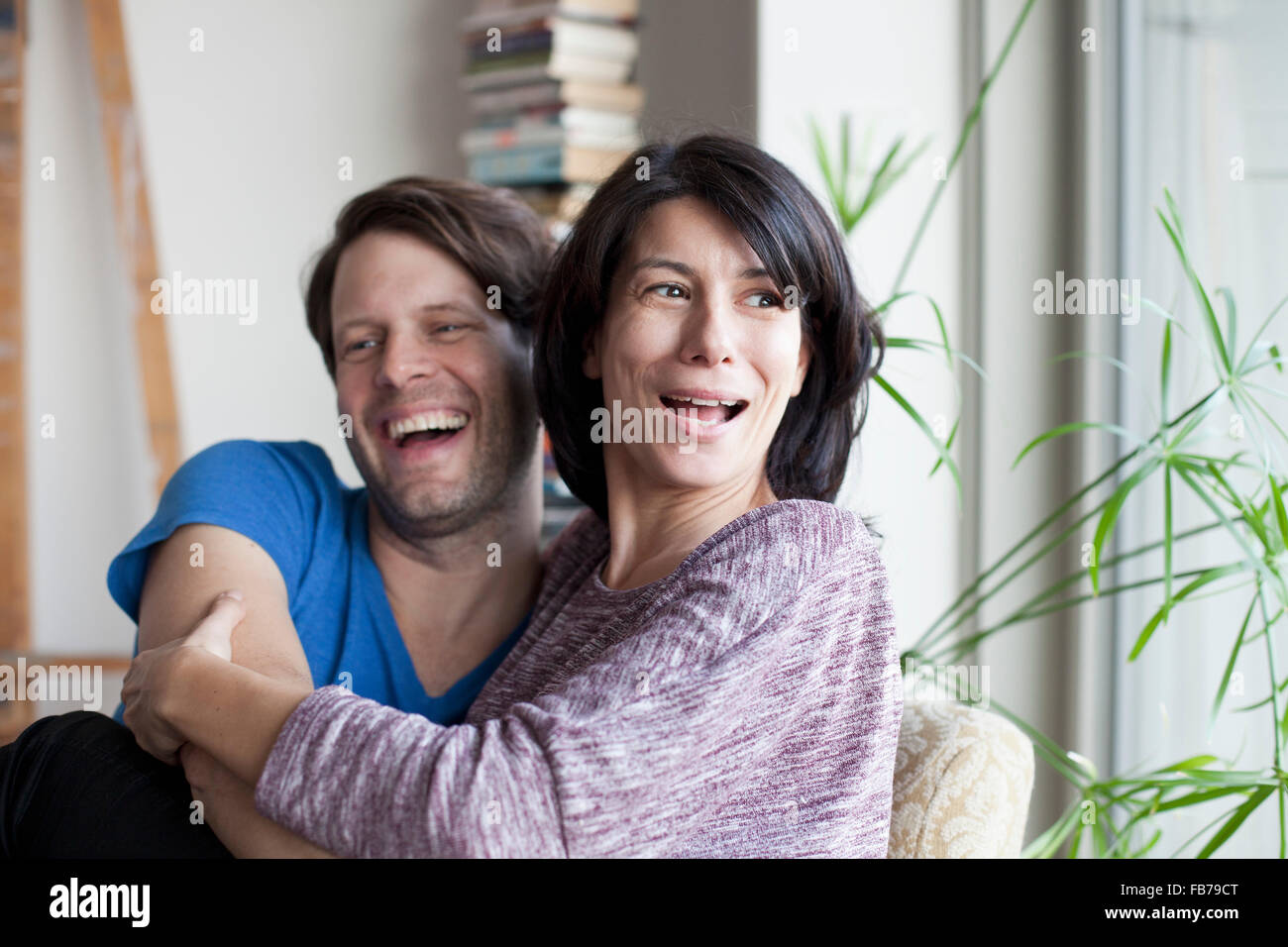 Mature couple embracing each other and smiling Stock Photo