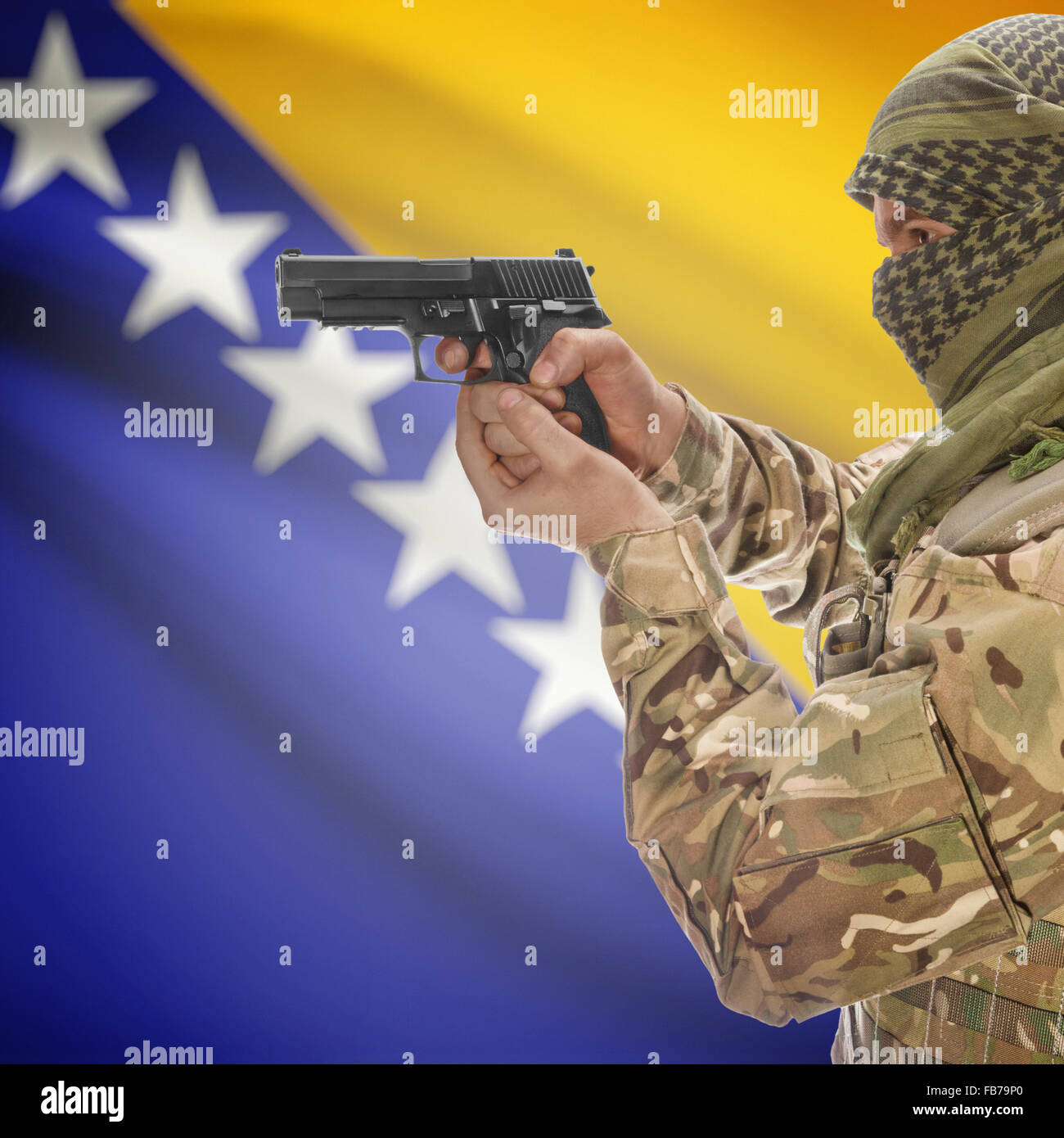 Man with gun in hand and national flag on background series Bosnia