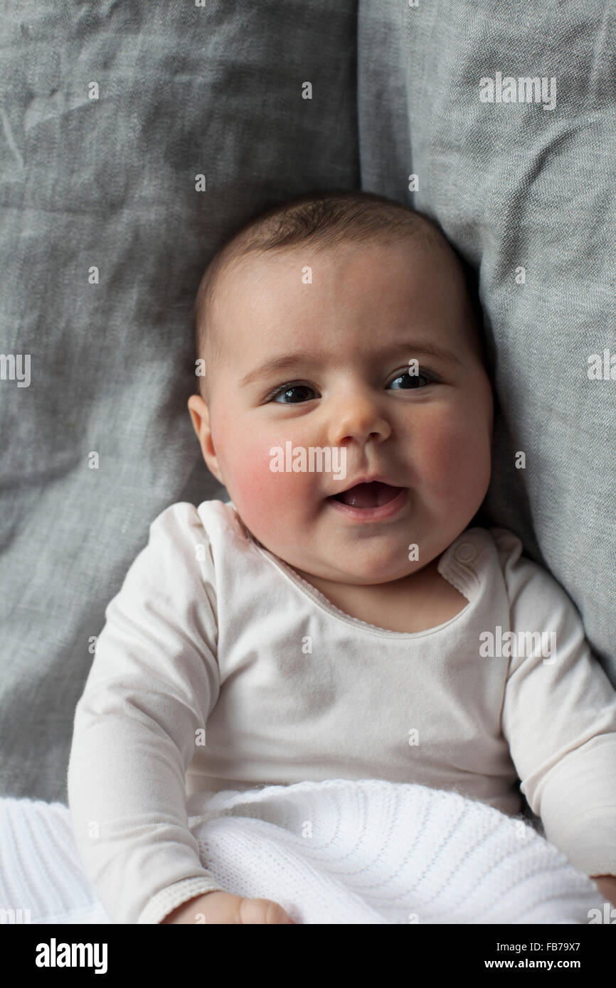 Directly above shot of baby girl lying in bed Stock Photo