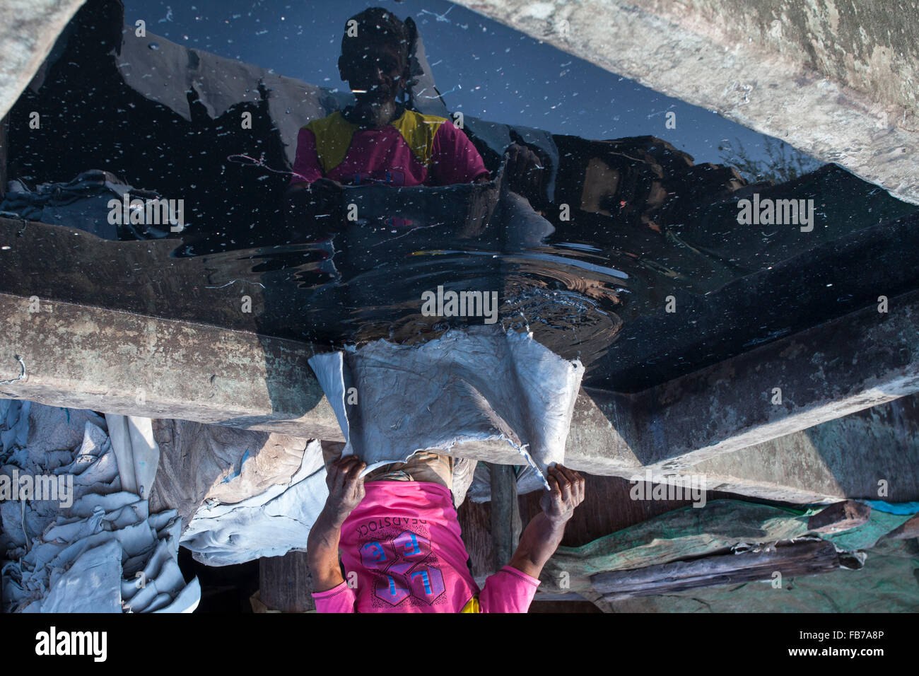 Dhaka, Bangladesh. 11th January, 2016. A worker washing leather using