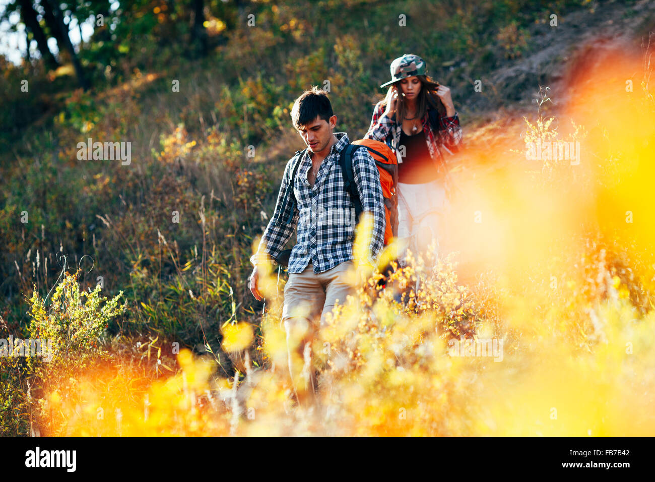 Man and woman hiking in forest Stock Photo