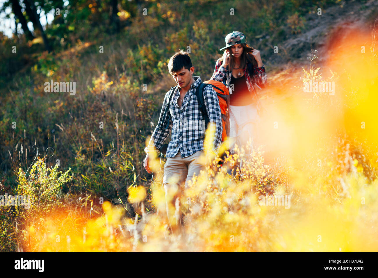 Man and woman hiking in forest Stock Photo - Alamy