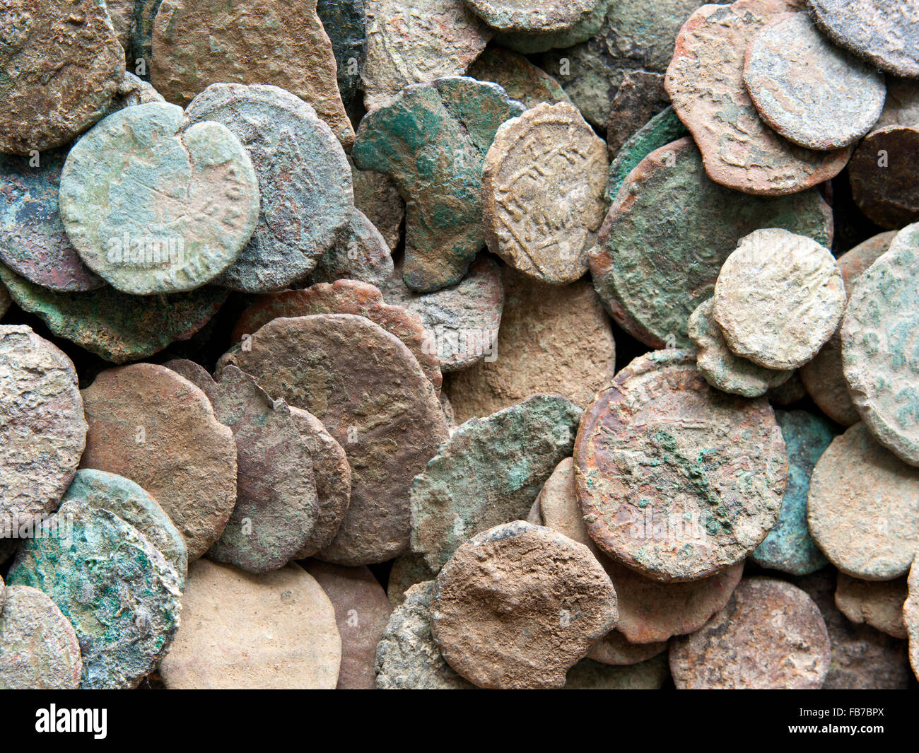 Pile of Roman coins showing the damaging effects farmer's acidic chemicals have on these copper bronze coins. Stock Photo