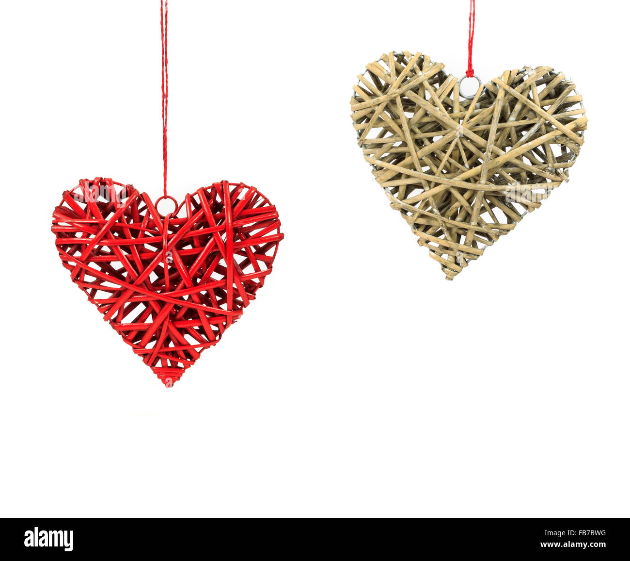 Two Valentines day wicker hearts hanging on red string isolated on a ...