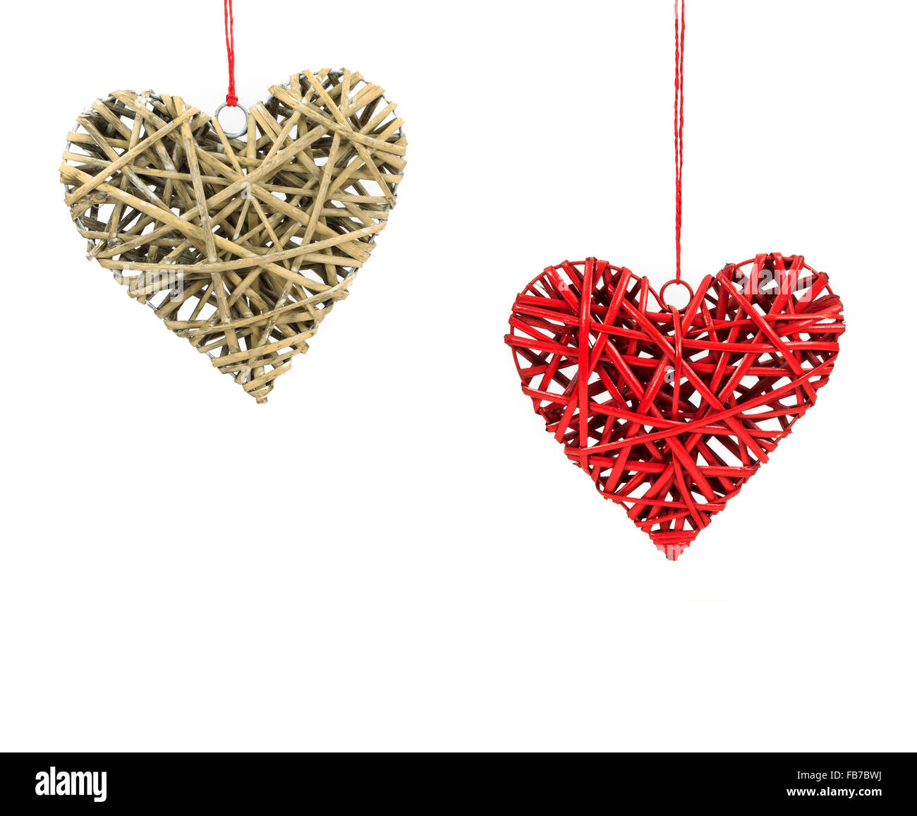 Two Valentines day wicker hearts hanging on red string isolated on a ...
