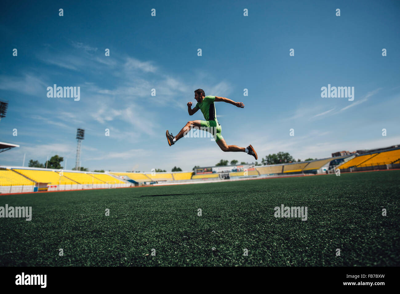 Full length of sporty young man running in stadium during training Stock Photo