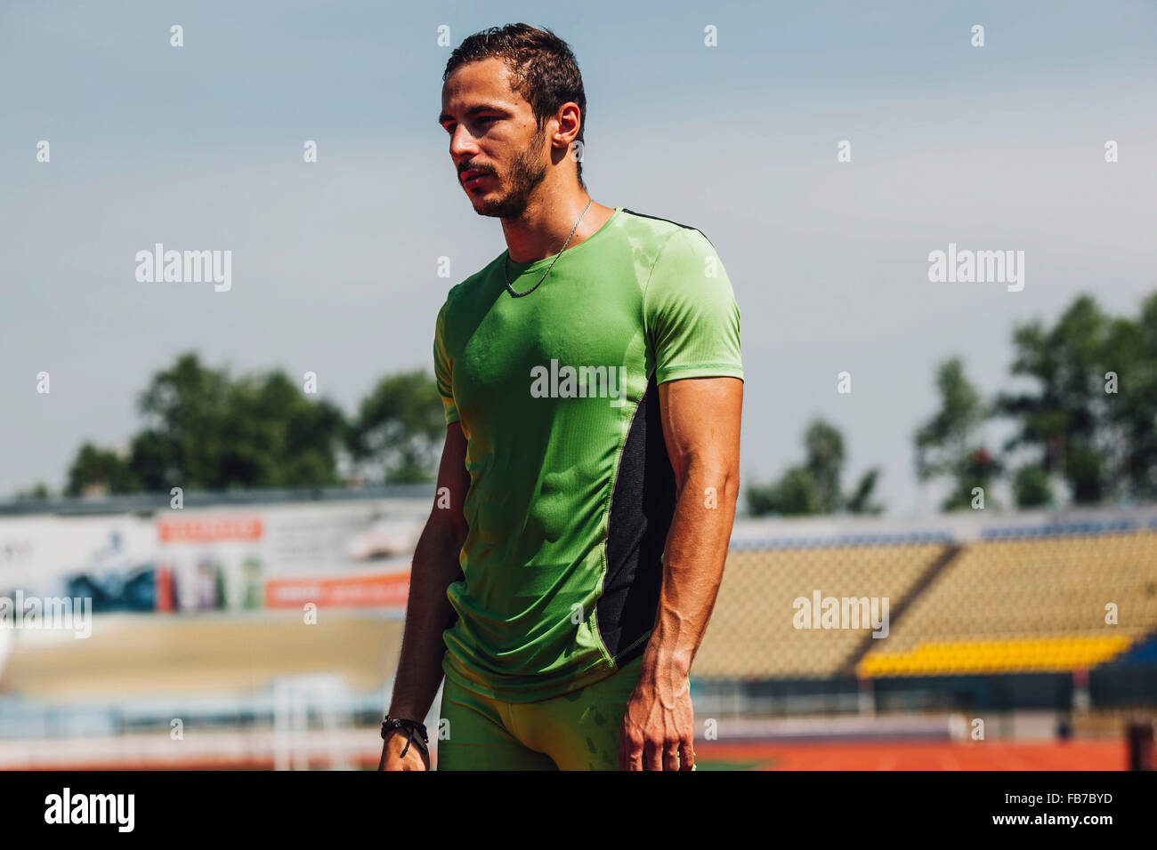 Young male athlete sweating in stadium Stock Photo