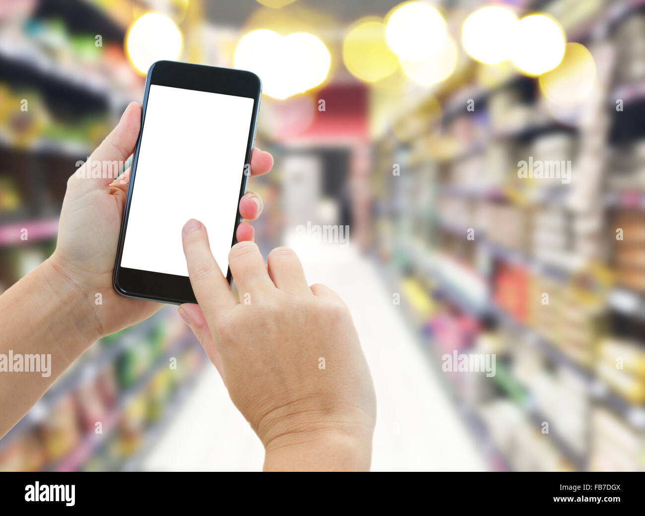 hand holding a modern smartphone in supermarket Stock Photo - Alamy