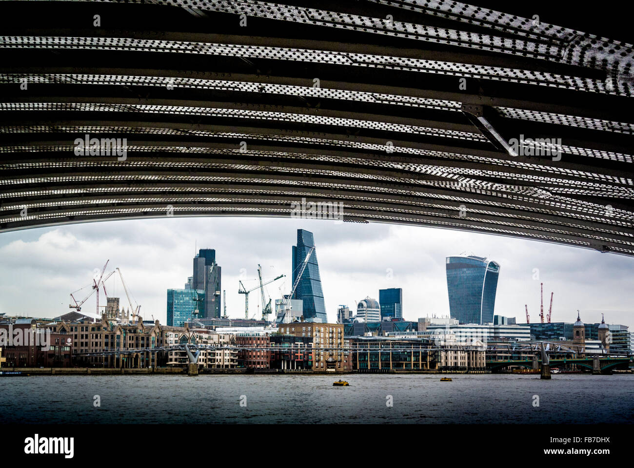 Financial district of London viewed through the arch of Blackfriars Bridge over the River Thames. Stock Photo