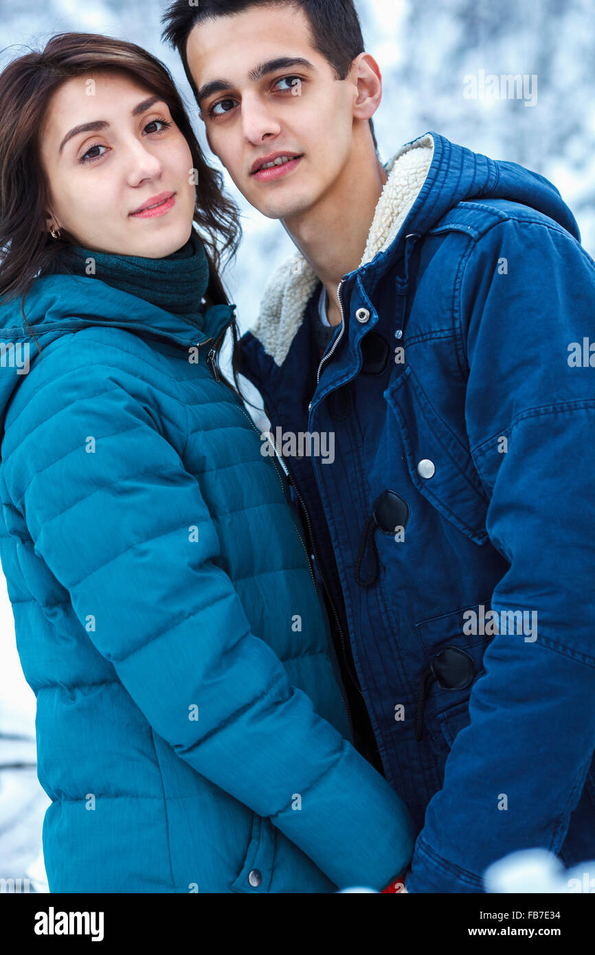 Loving young couple in warm clothing looking away Stock Photo