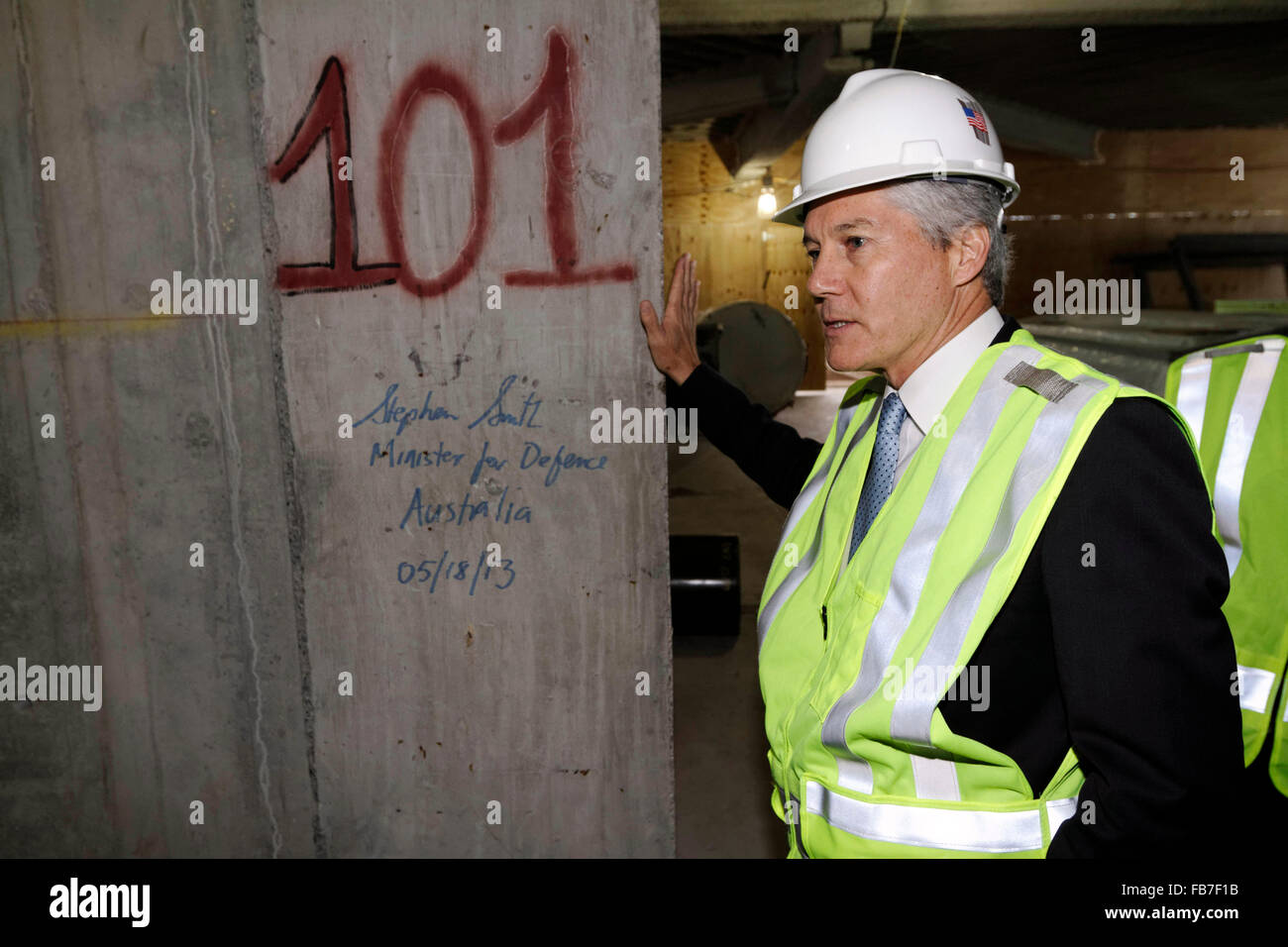 Australian Minister for Defence Steven Smith signs his name on unfinished structure of the 101'st floor of the Freedom Tower Stock Photo