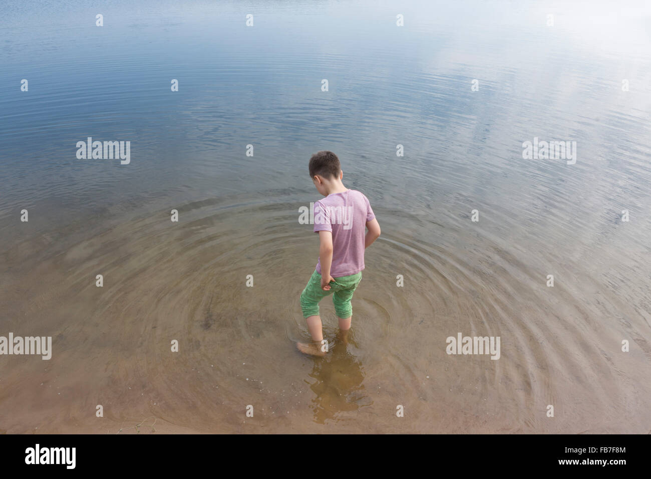 High angle view of boy standing in lake Stock Photo