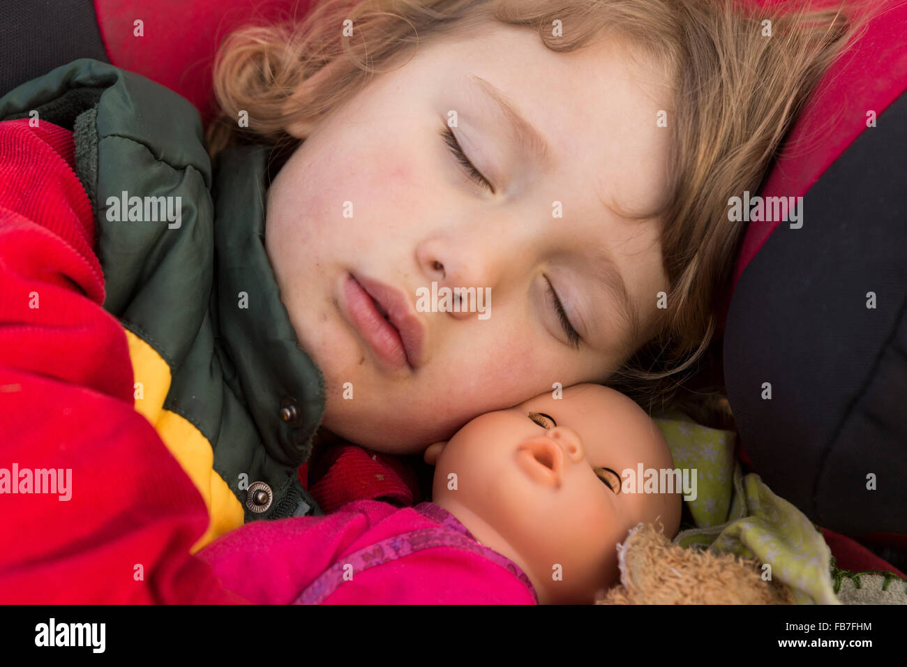 Close-up of cute girl sleeping with doll Stock Photo
