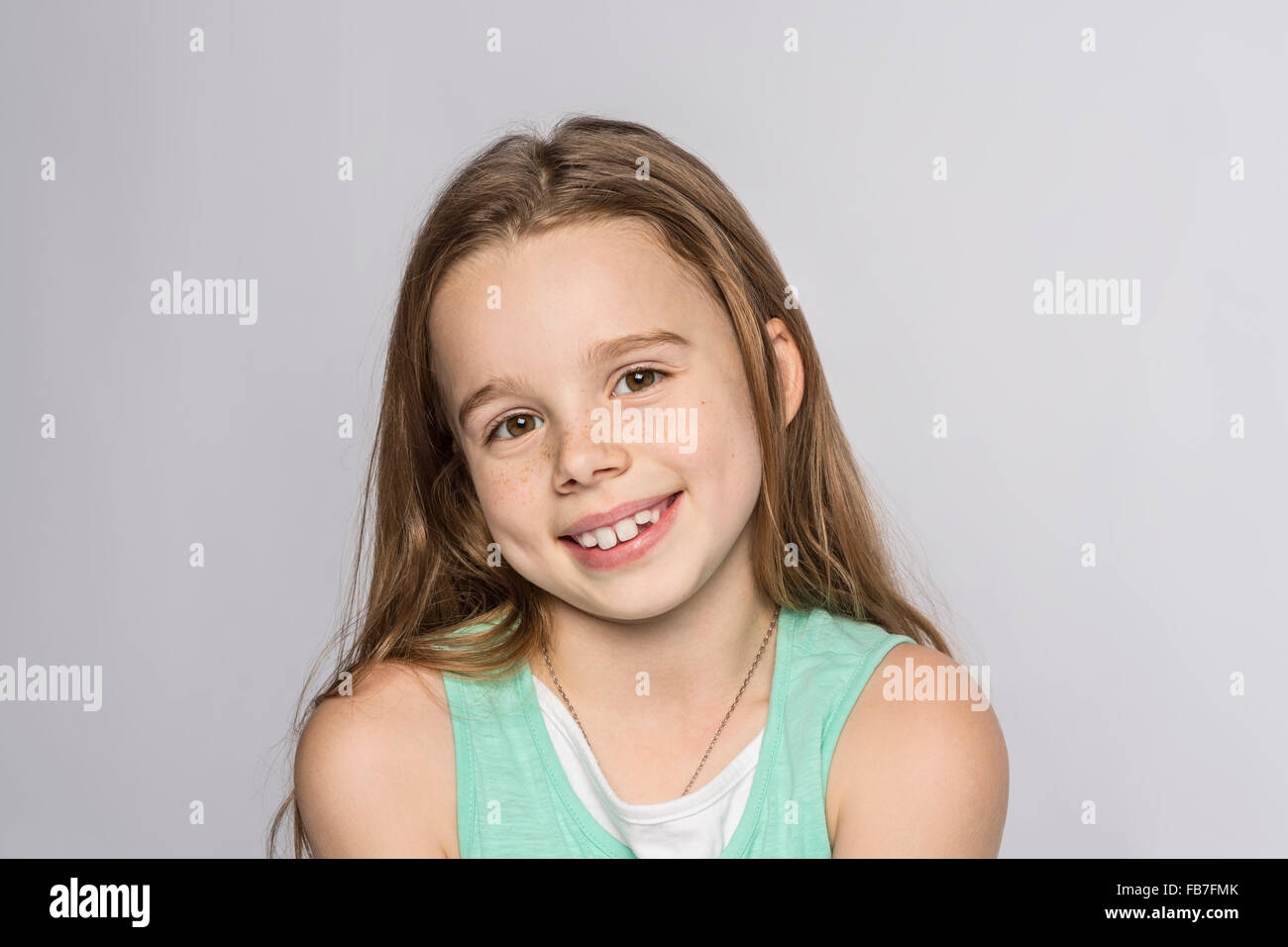 Portrait of happy girl against white background Stock Photo