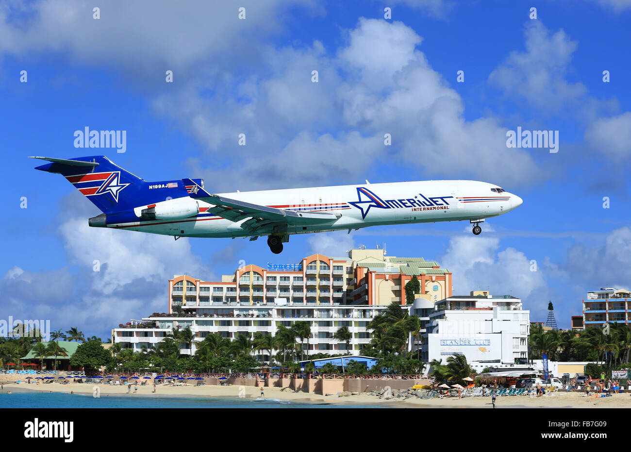 An Amrijet cargo Boeing 727 low over Maho Beach arriving at Sint Maarten (SXM) in the Caribbean Stock Photo
